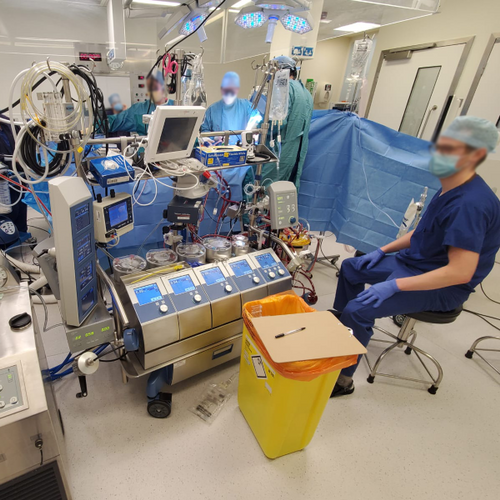 Surgical team performing a cardiac procedure with perfusion support